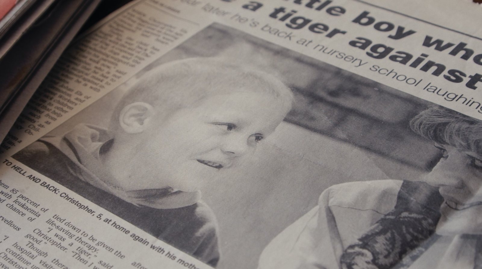 Newspaper clipping about Christopher, five years old, back home after treatment
