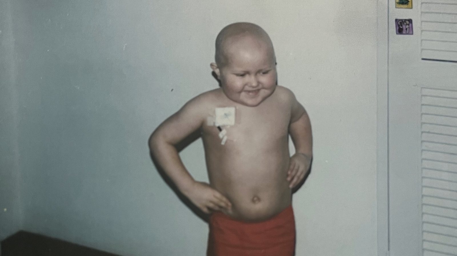 Chris as a small boy in hospital with a chemo line taped to his chest