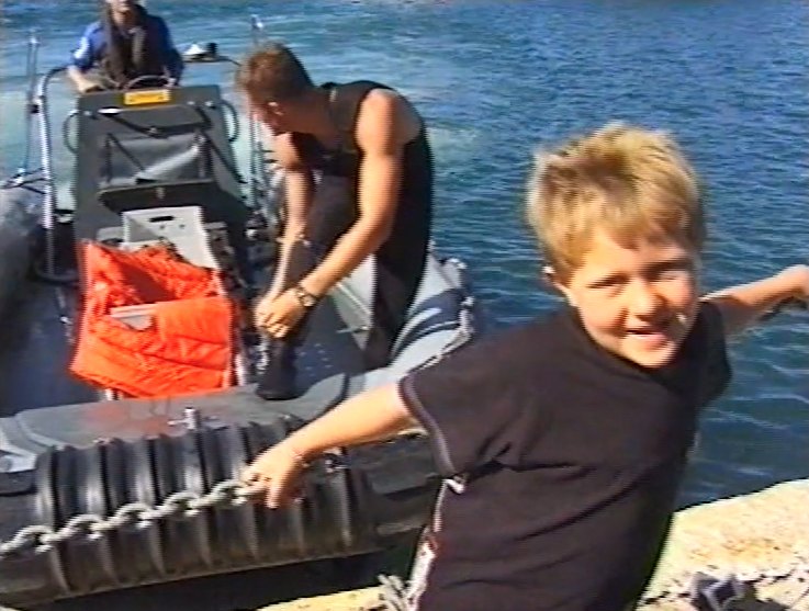 Chris as a boy climbing off a navy boat at the harbour